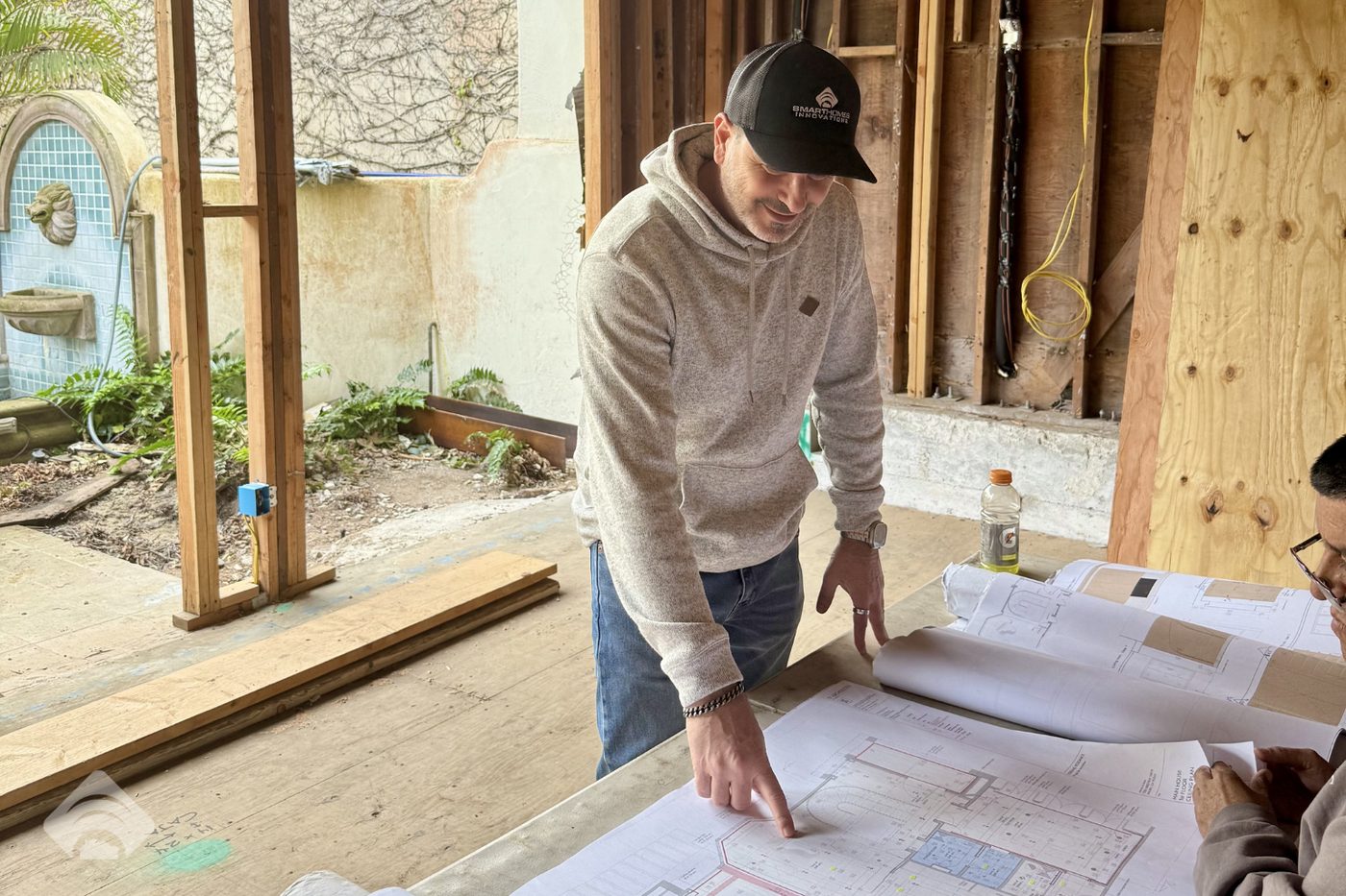 Lior Hamuel reviewing plans on a job site